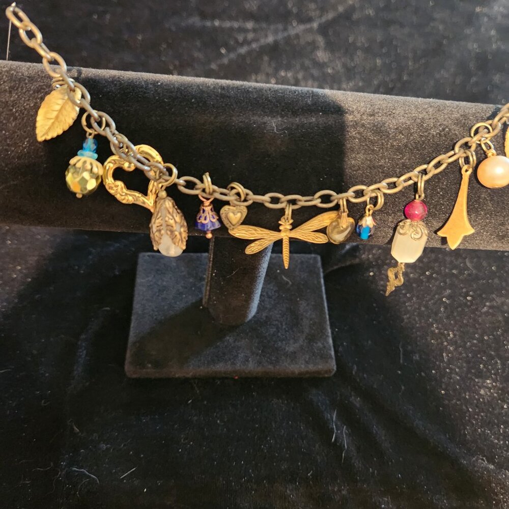 Vintage charm bracelet, 7.25 inches long, with gold colored charms